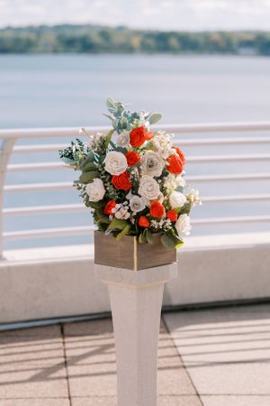 Wedding ceremony details at Monona Terrace Rooftop with red flowers. Classic and film-inspired wedding photography in Madison, Wisconsin.