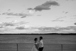 Bride and groom portrait on the Monona Terrace Rooftop at sunset. Classic and film-inspired wedding photography in Madison, Wisconsin.
