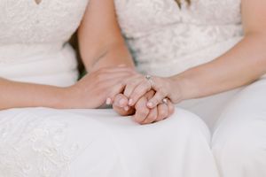 Classic and film-inspired wedding photography in Madison, Wisconsin. Intimate holding hands two brides gay couple portrait wedding dress