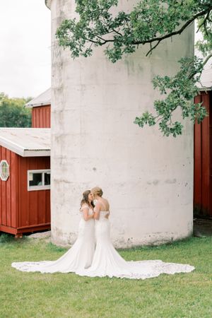 Brides first look on a farm wedding with a silo and under a tree. Classic and film-inspired wedding photography in Madison, Wisconsin.