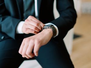 Groom detail photo of watch and jacket with cuff links. Classic and film-inspired wedding photography in Madison, Wisconsin.