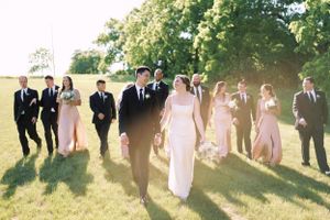 Wedding party walking in a summer backlit candid portrait. Classic and film-inspired wedding photography in Madison, Wisconsin.
