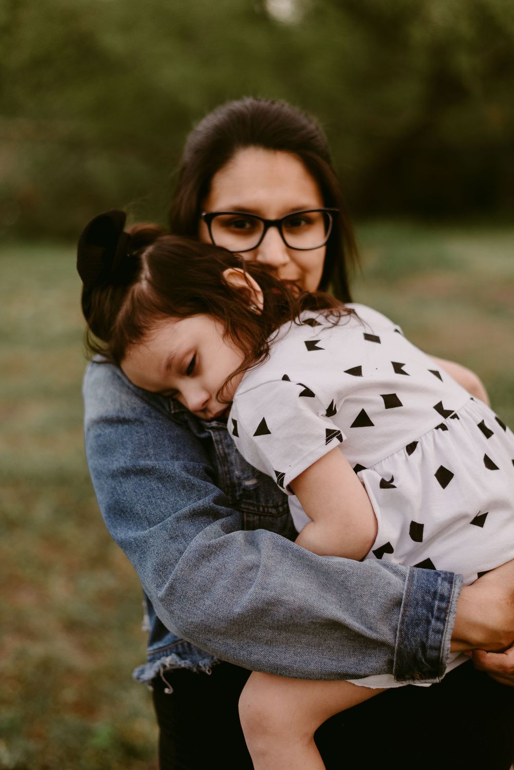 Tender moment captured while wearing denim jacket outdoors.