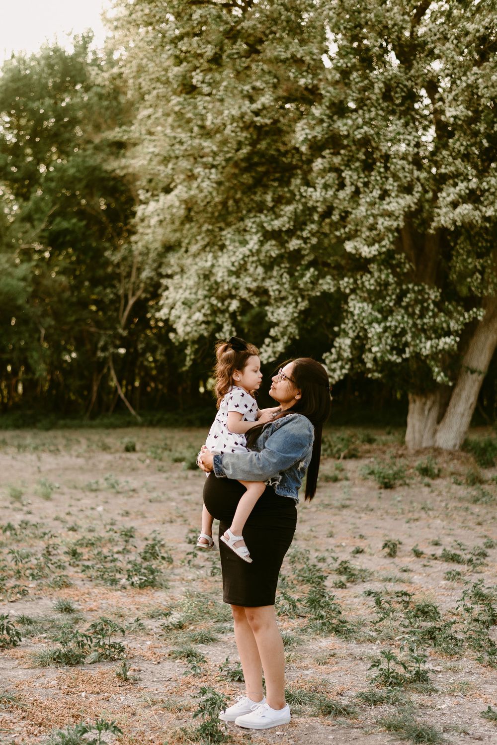 Joyful outdoor moment under blooming trees in springtime.