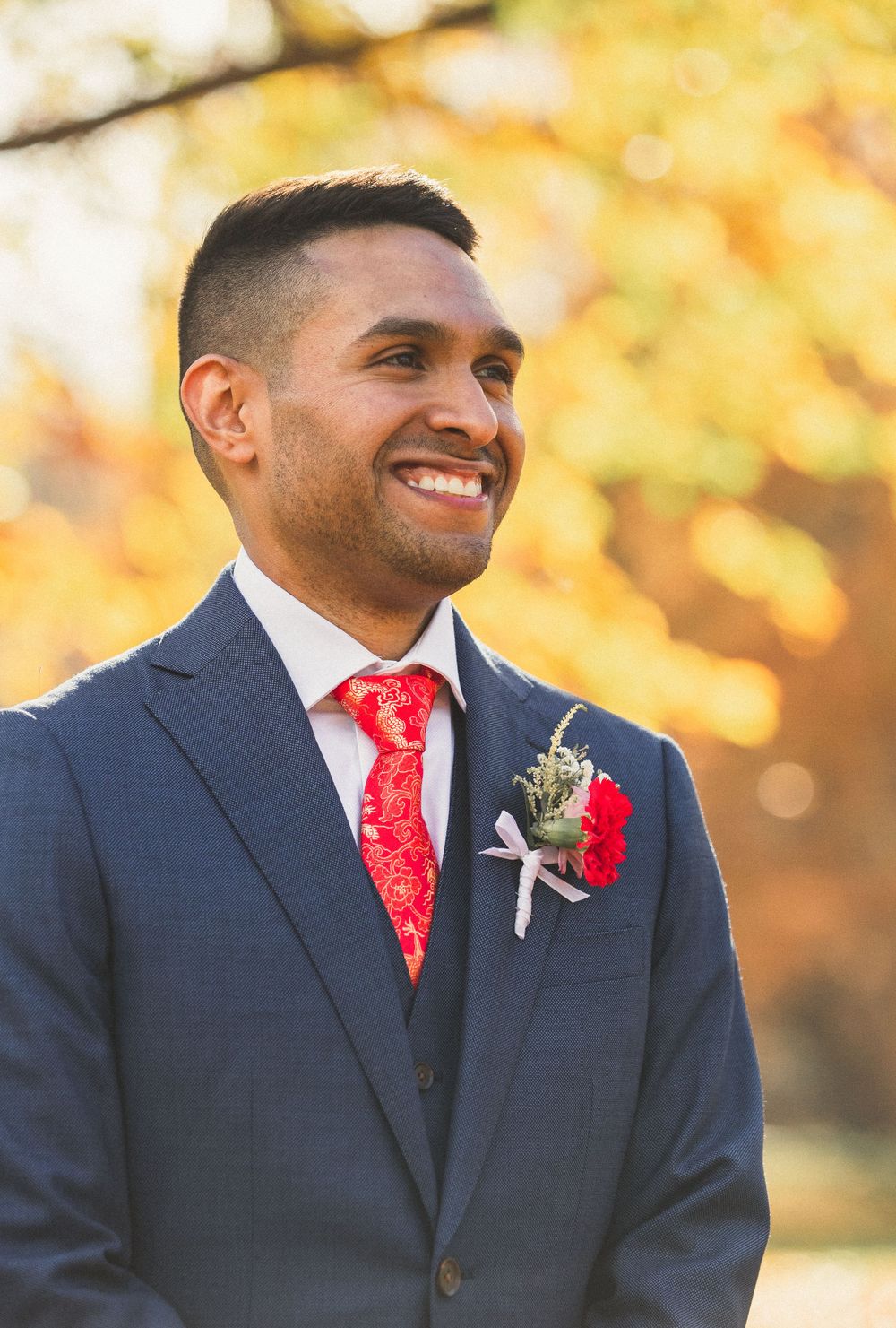 Portrait of groom brimming from ear to ear at a fall Brookside Gardens wedding