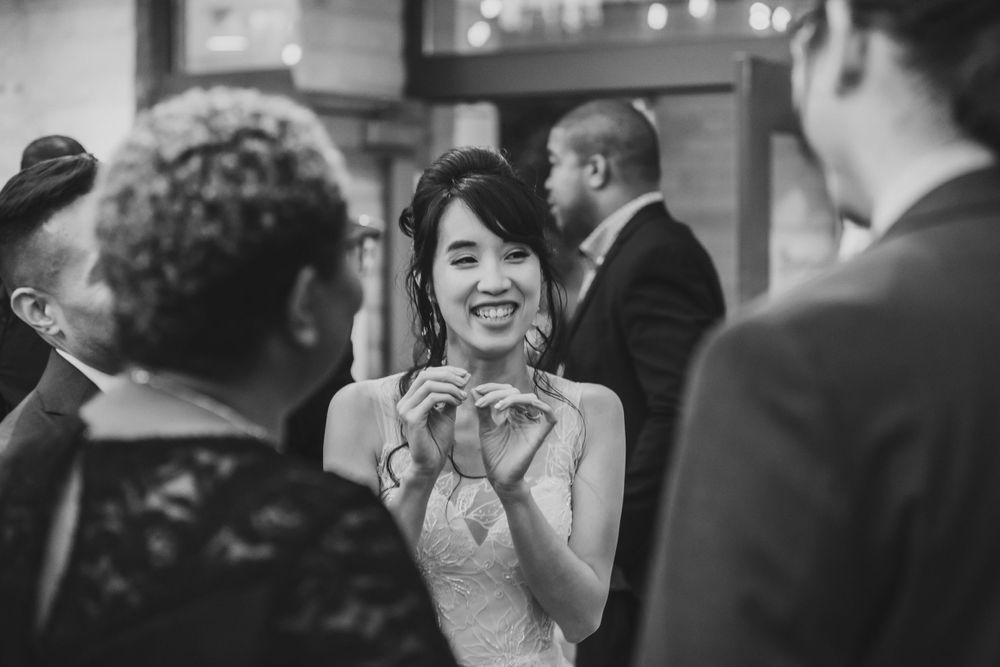 A celebration moment captured in black and white at an indoor reception.