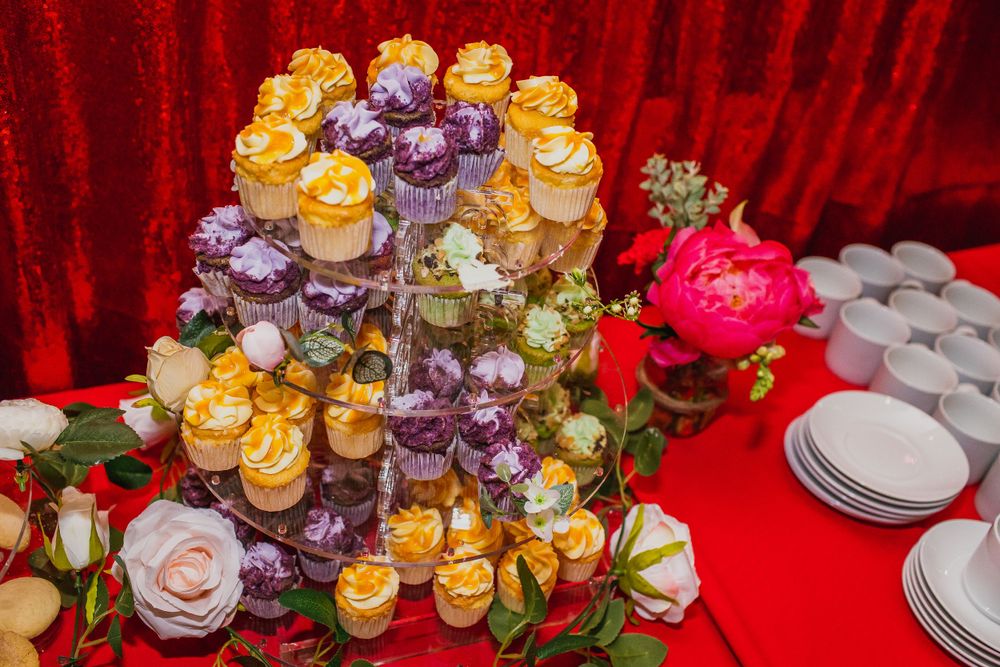 Gold and purple cupcakes on display at a wedding