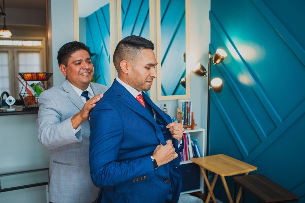 Wedding at Brookside Gardens. Groom getting ready at home with help of father