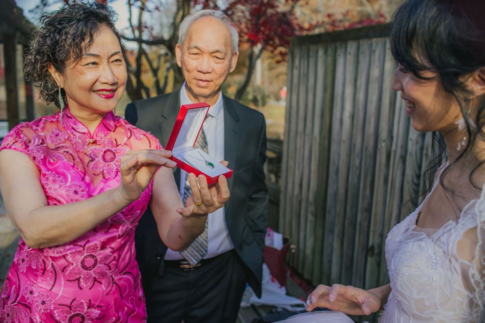 Tea ceremony celebration during wedding reception with traditional pink qipao dress.
