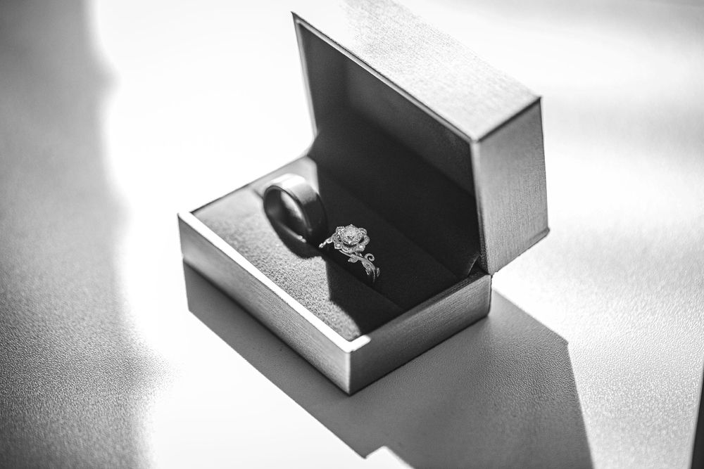 Detail shot of bride and groom wedding rings in black and white