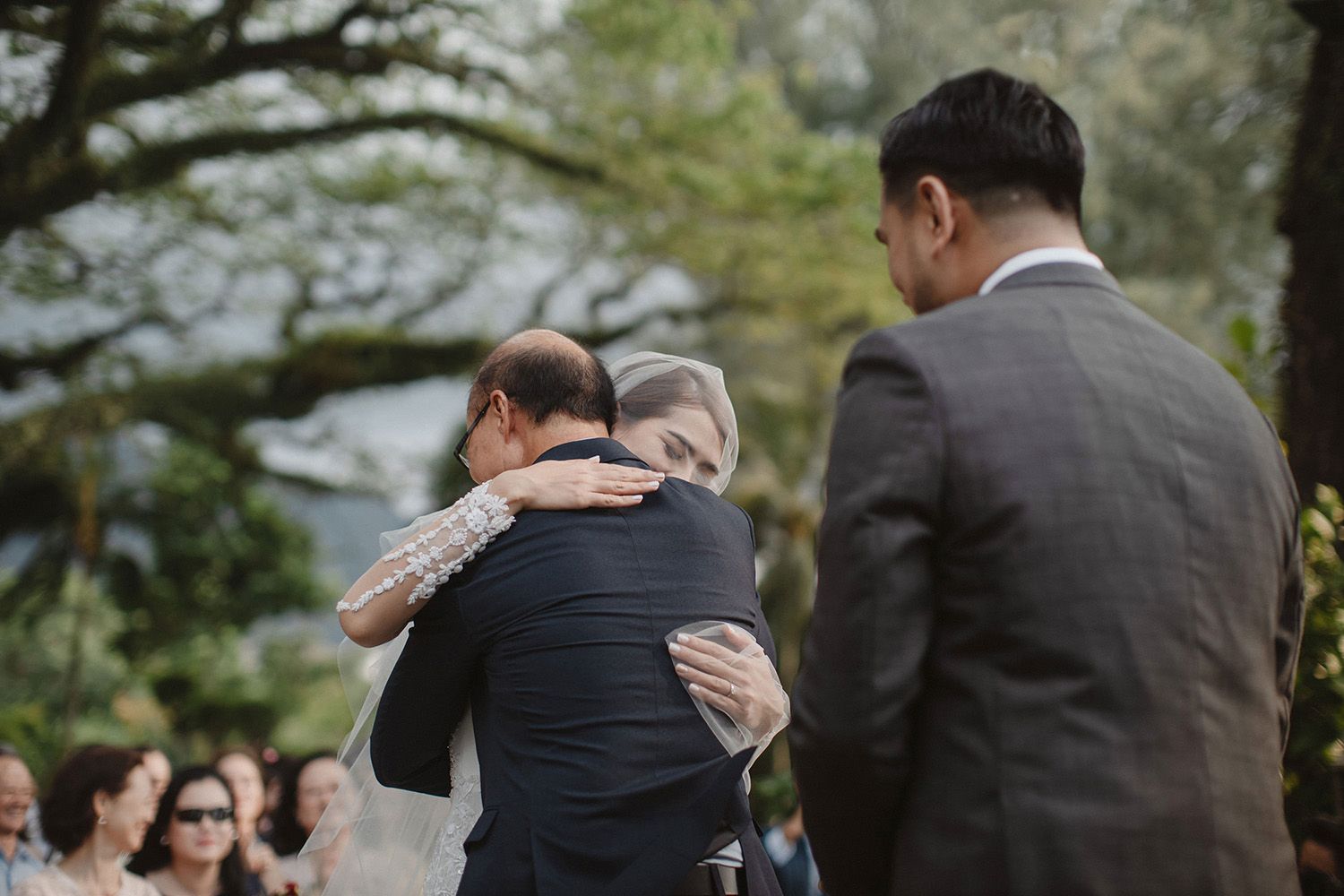 bride giving her dad a hug after walking down the isle in Penang Rasa Sayang