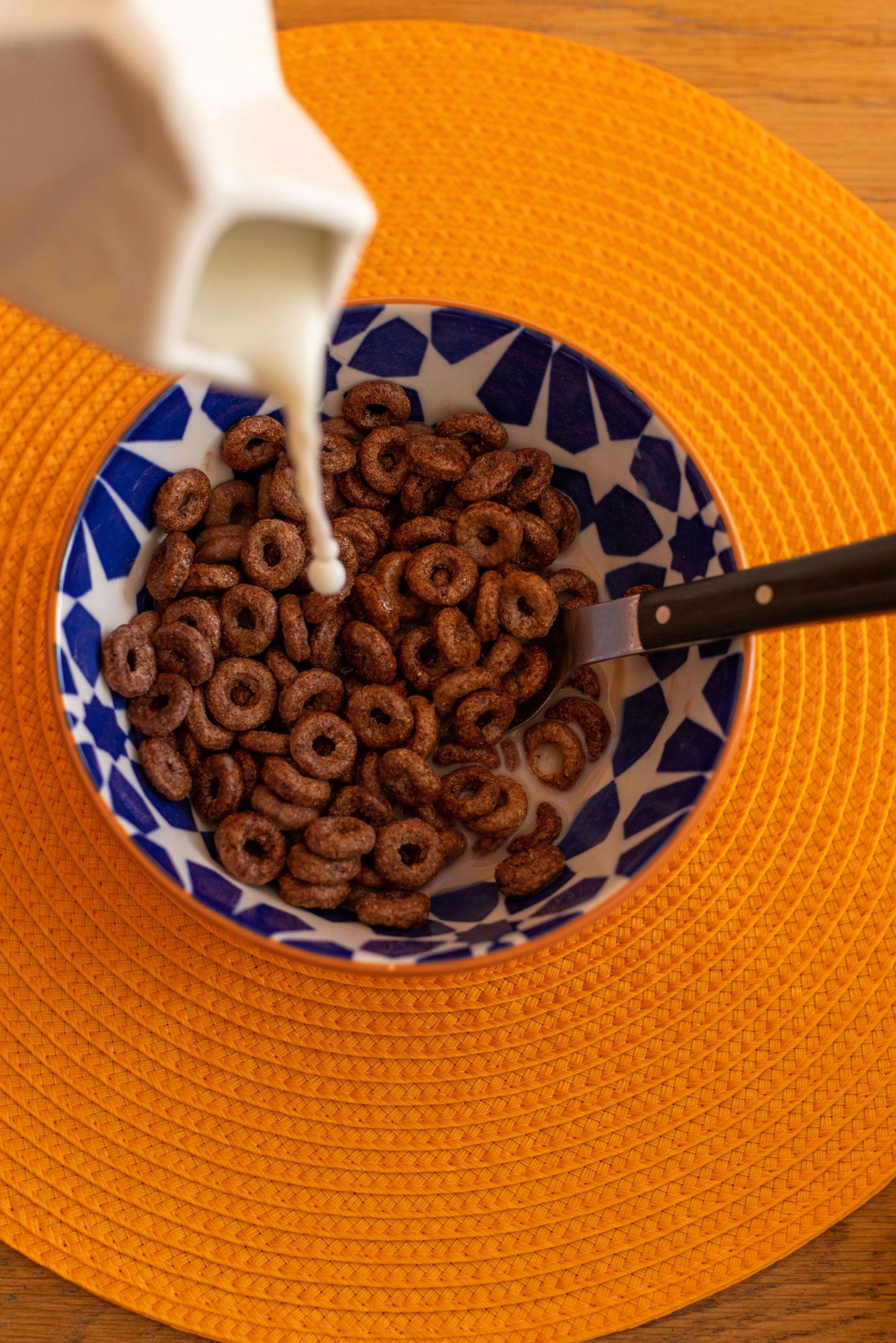 Close up of milk being poured into chocolate orange weetos cereal for an instagram ad for influencer marketing.