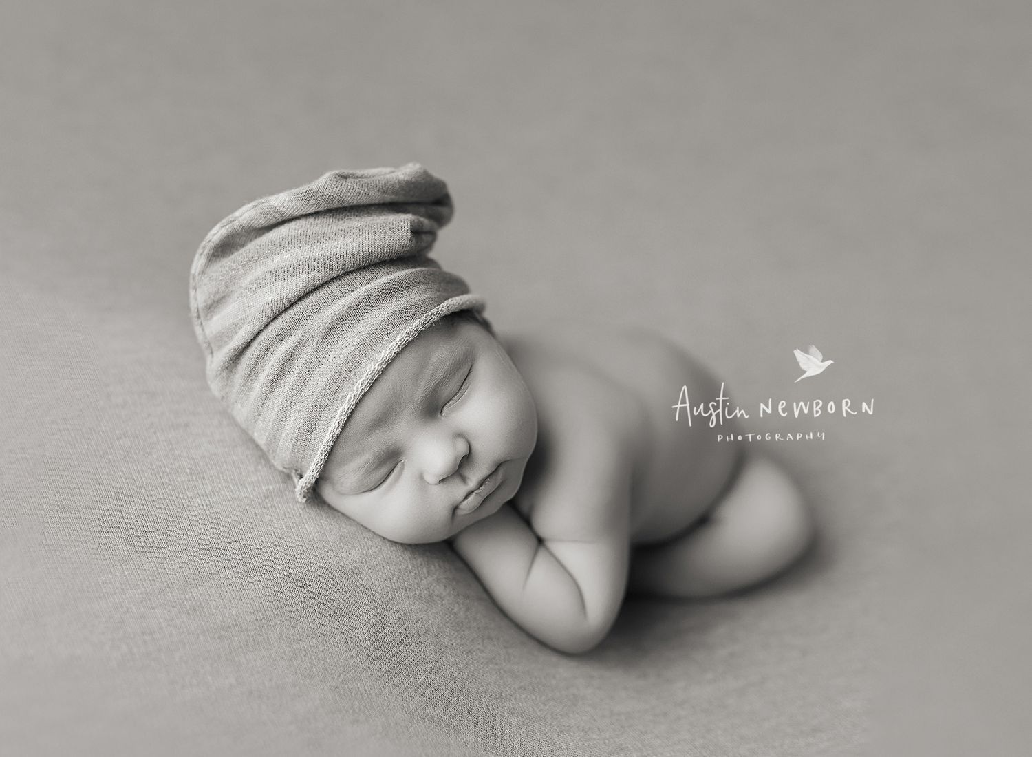 austin newborn photography sleeping newborn taco pose hipster hat black and white