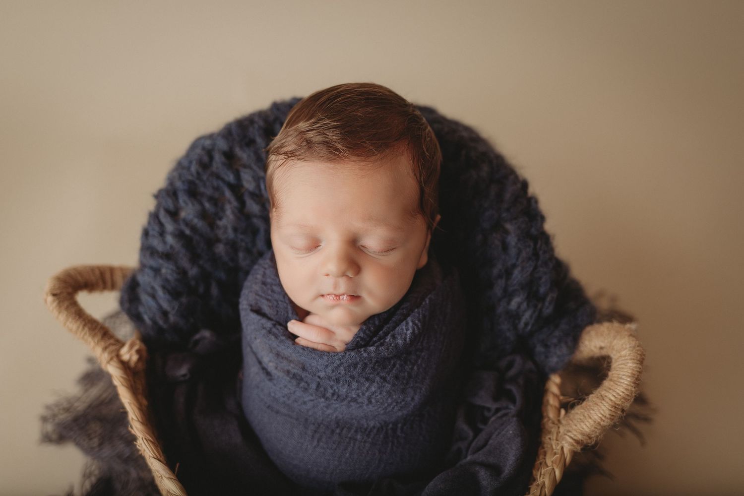 blue and brown new baby boy in basket
