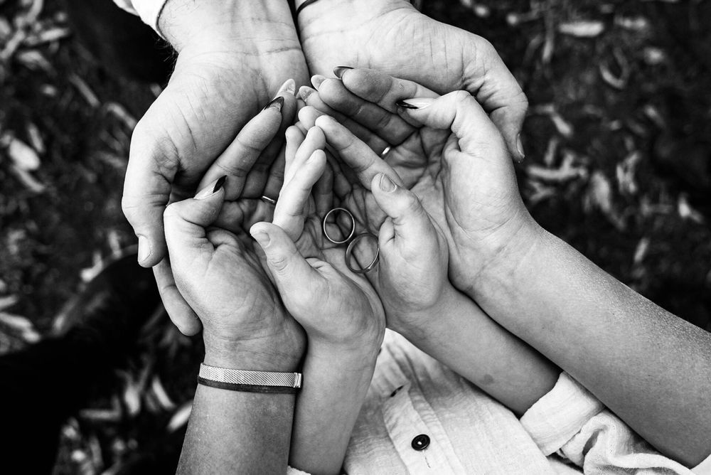 Close-up shots of hands holding and sharing ultrasound photos.