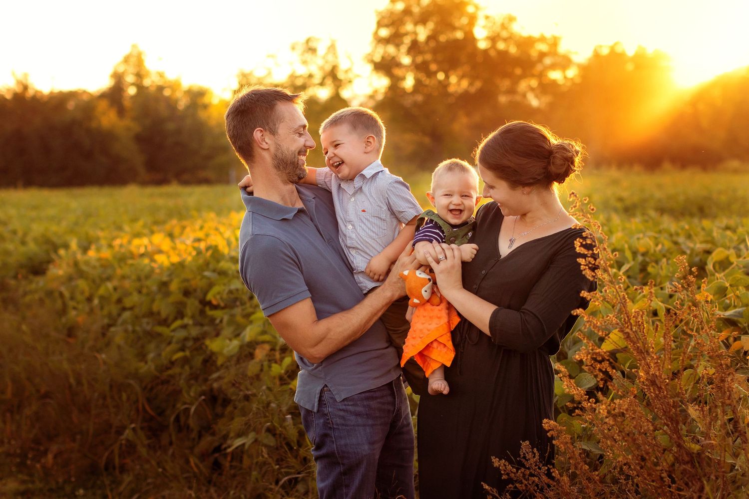 family laughing together in sunset