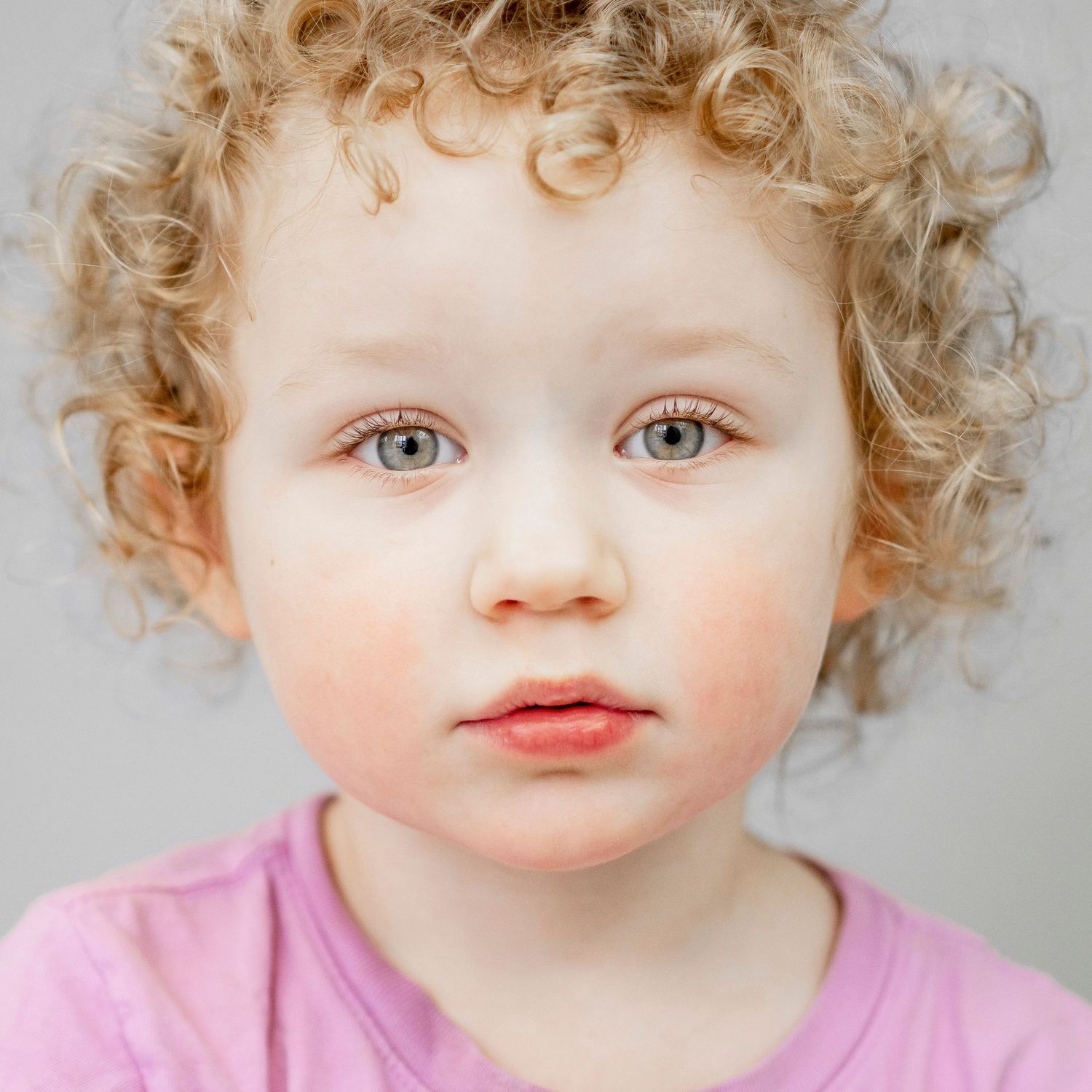 Preschool aged girl, beautiful ringlets, solid grey backdrop