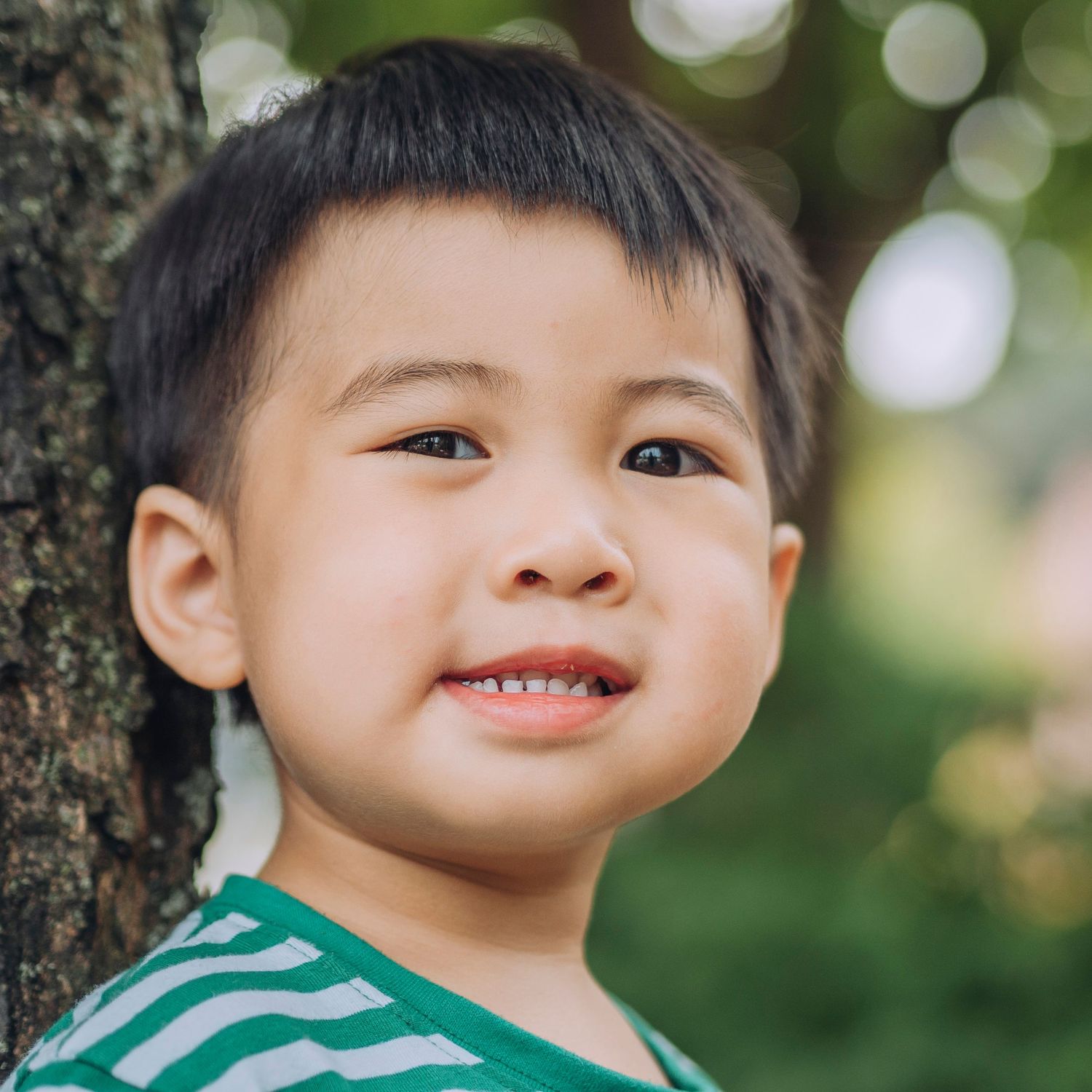 Pre-school aged boy, outdoor background.