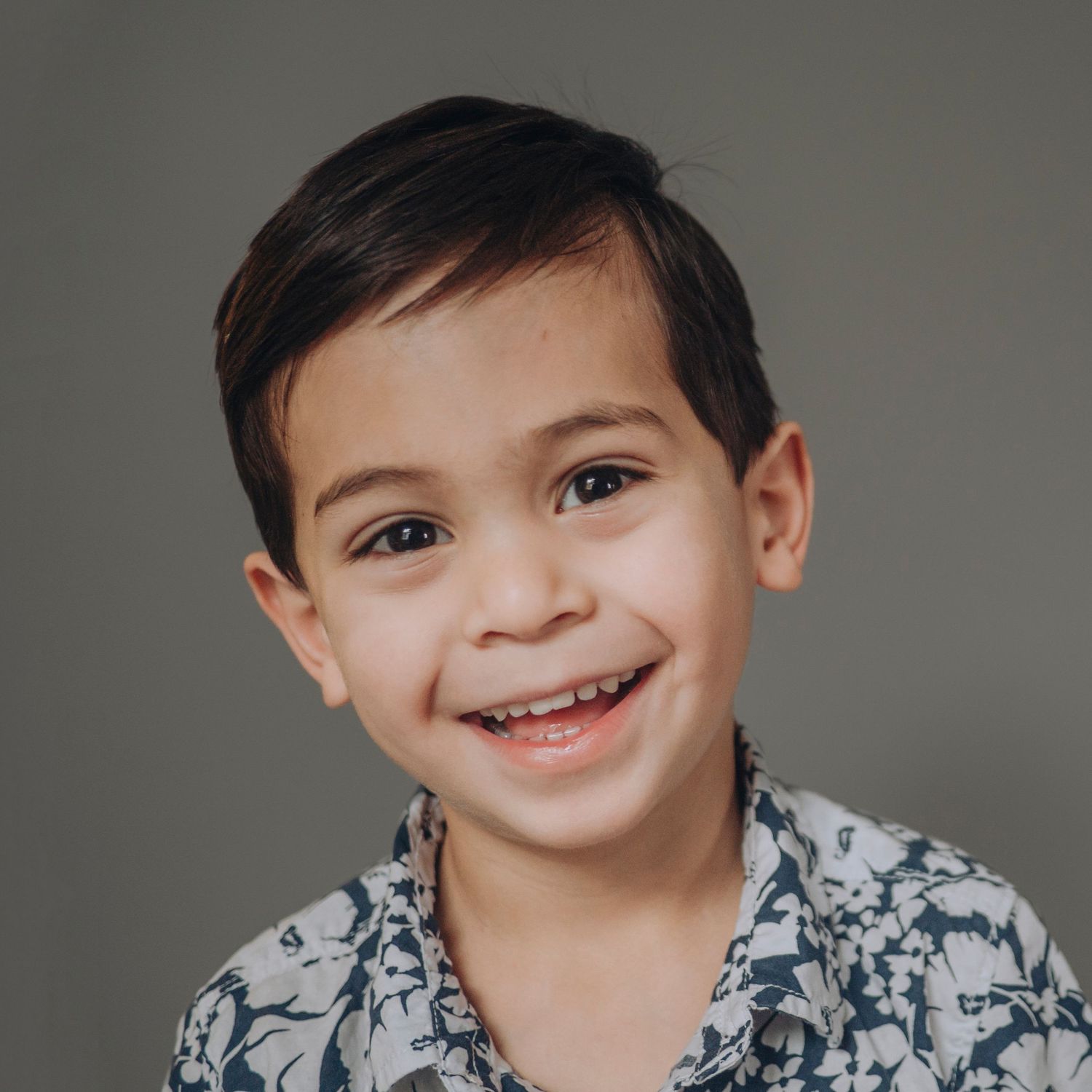 Pre-school aged boy, solid grey background.