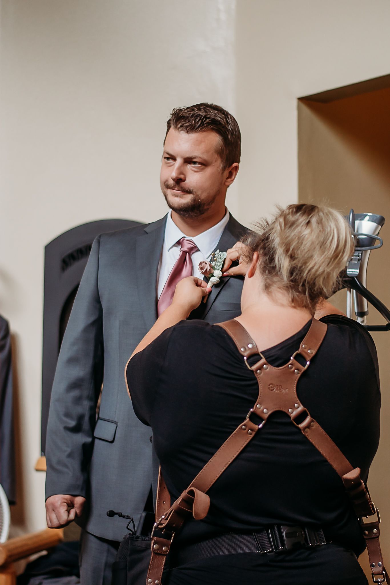 Photographer with professional camera gear working at formal event.