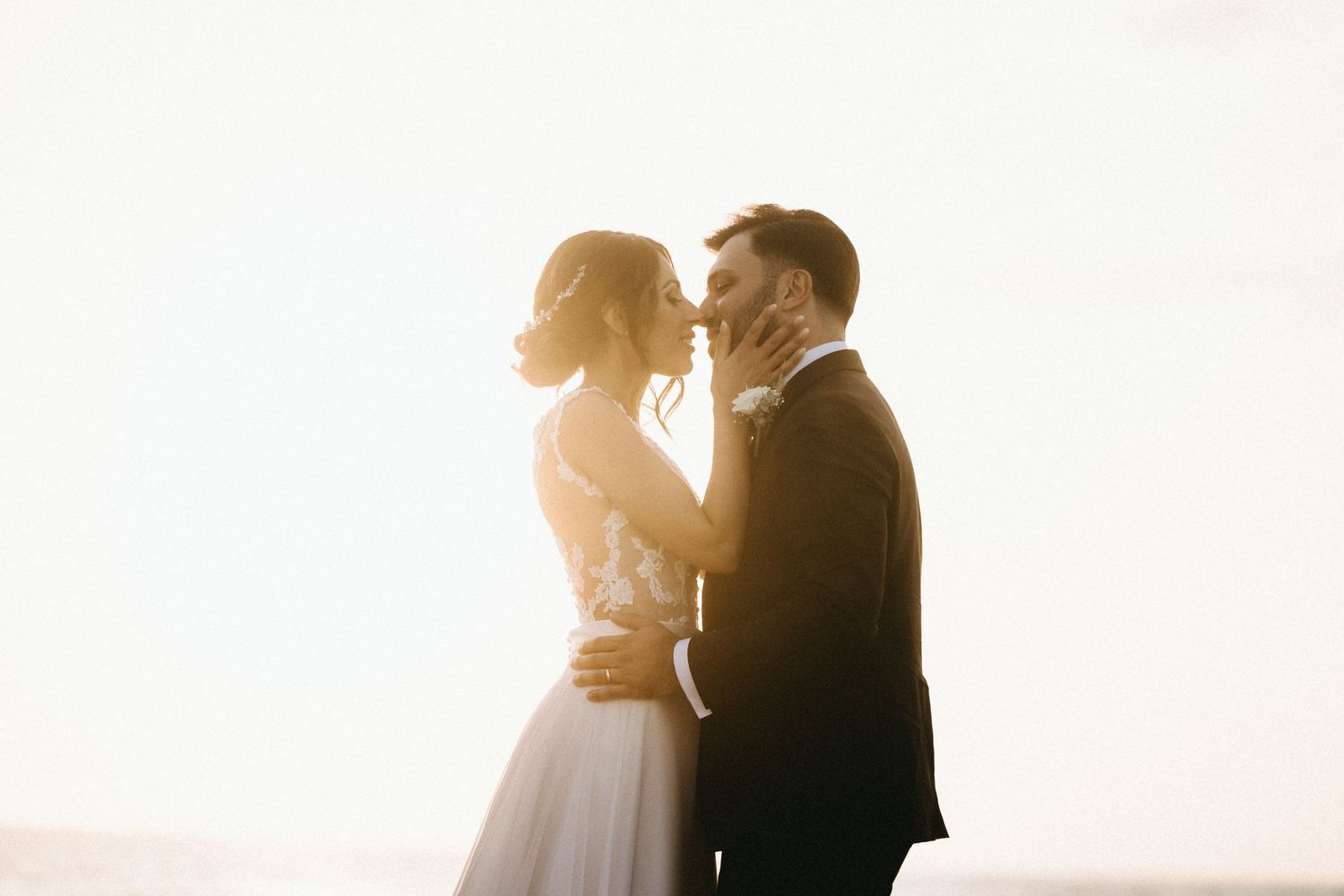 Romantic silhouette photos of a couple embracing during golden hour.