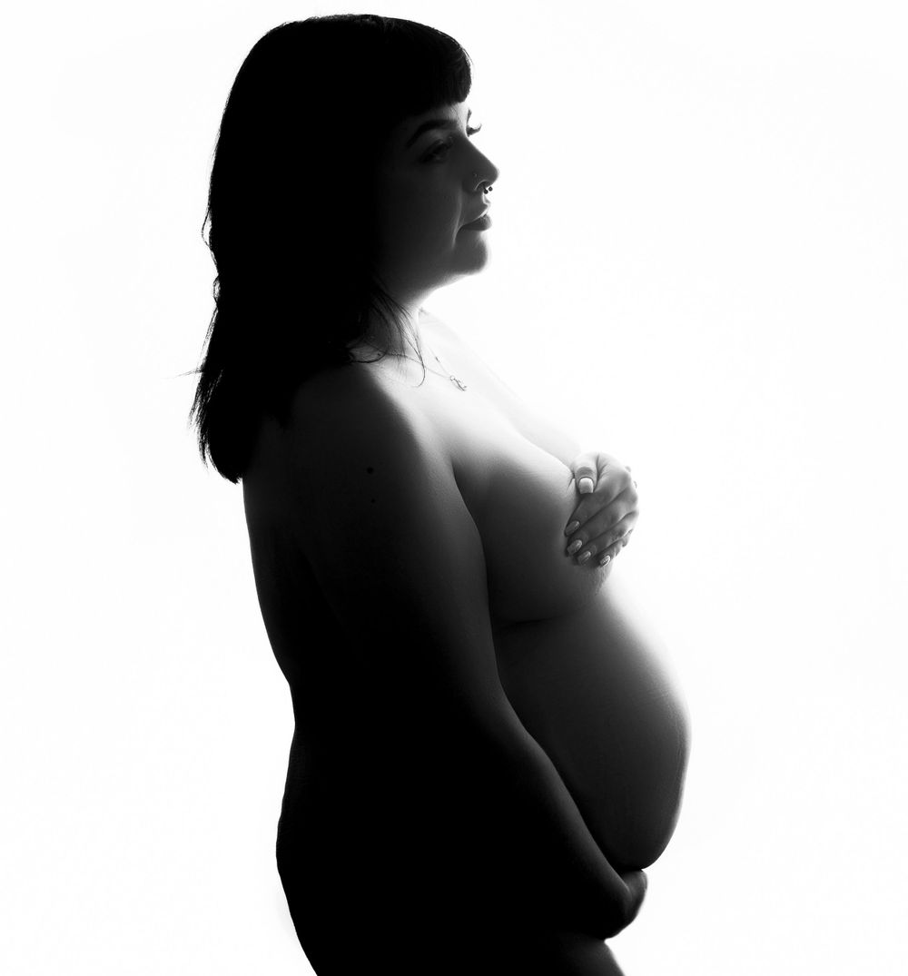 Pregnant woman nude silhouette at her maternity session photographed by maternity photographer in swansea