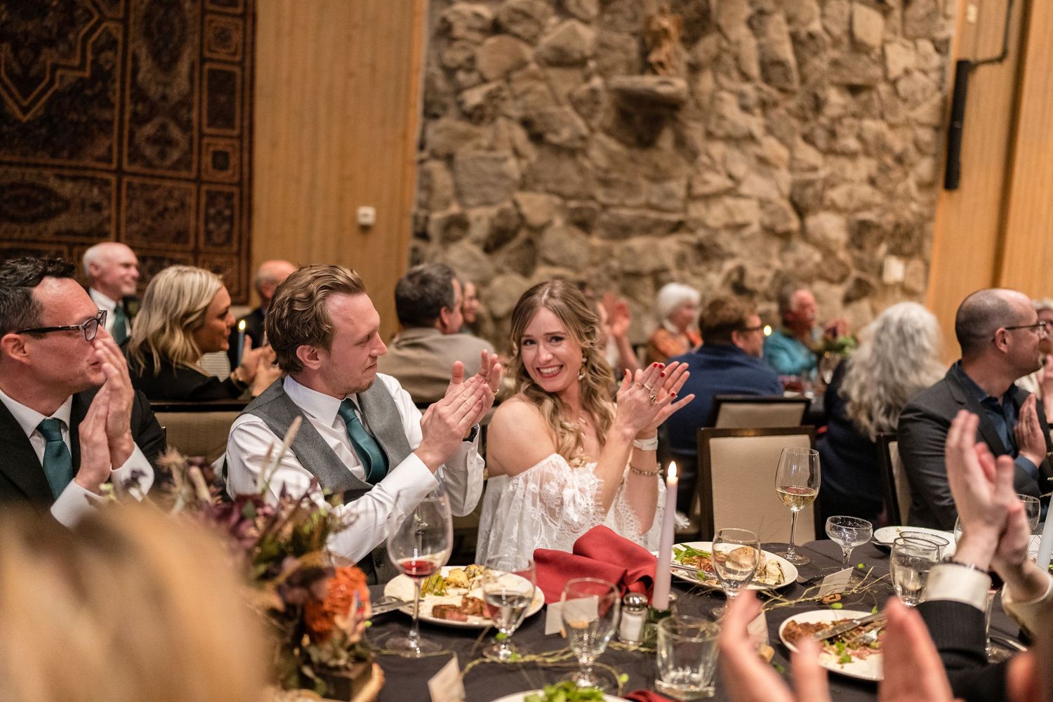 Wedding reception dining scene with guests enjoying a celebratory meal.