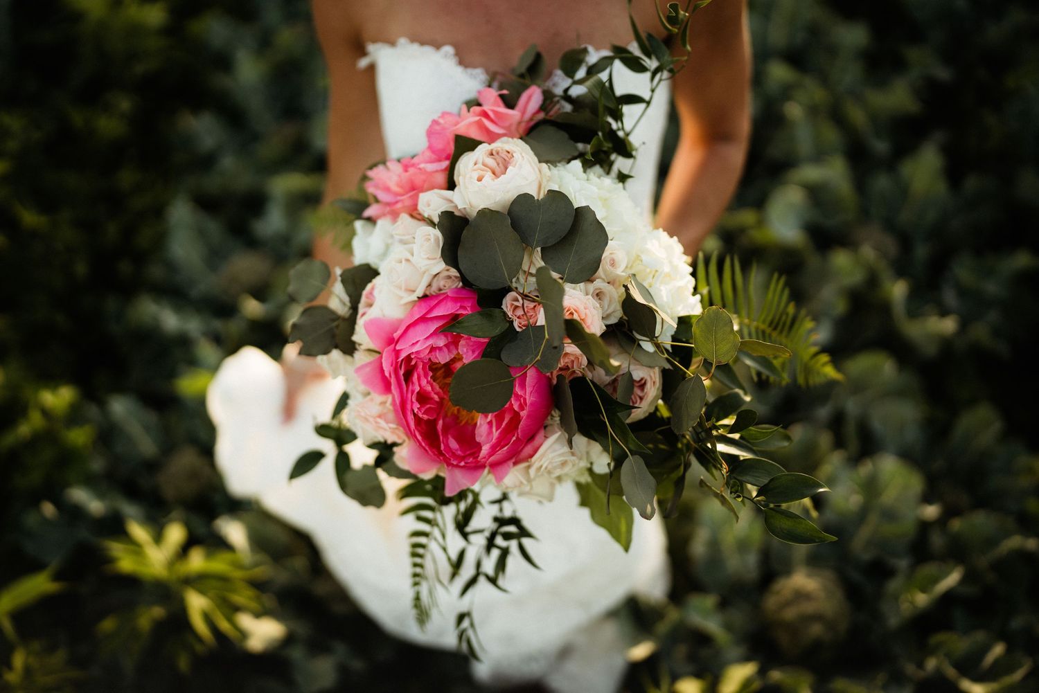 Stunning bridal bouquet featuring pink peonies, white flowers and cascading greenery.