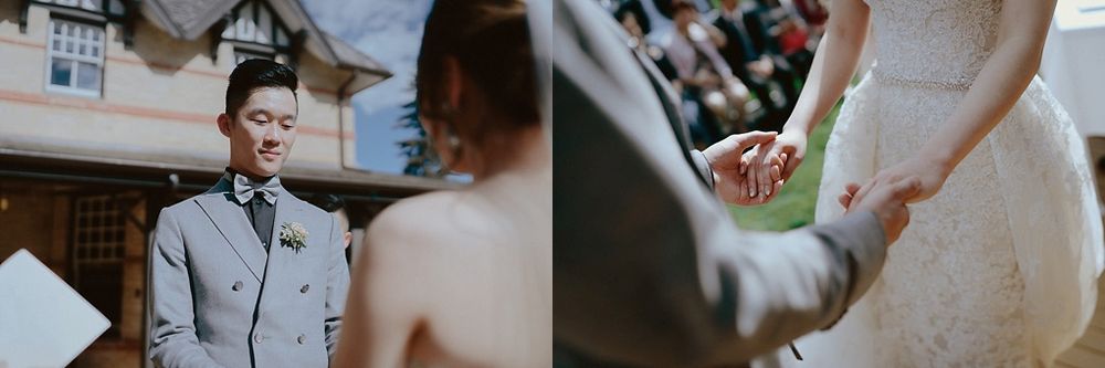Close-up details of a wedding couple holding hands and exchanging rings at their ceremony.