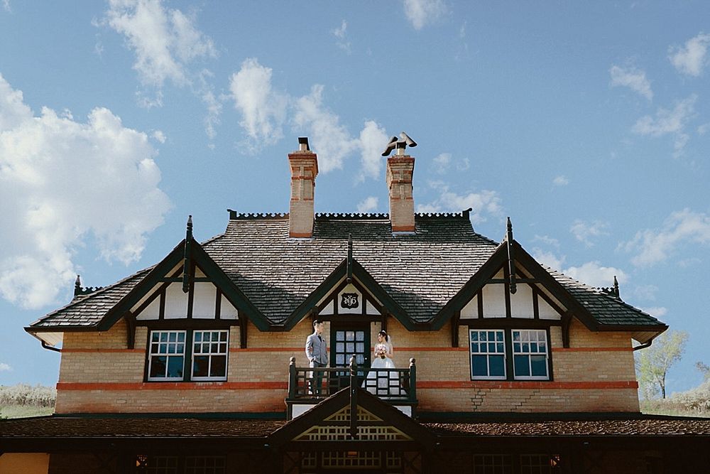 Panoramic view of a historic Tudor-style mansion roofline with distinctive chimneys.
