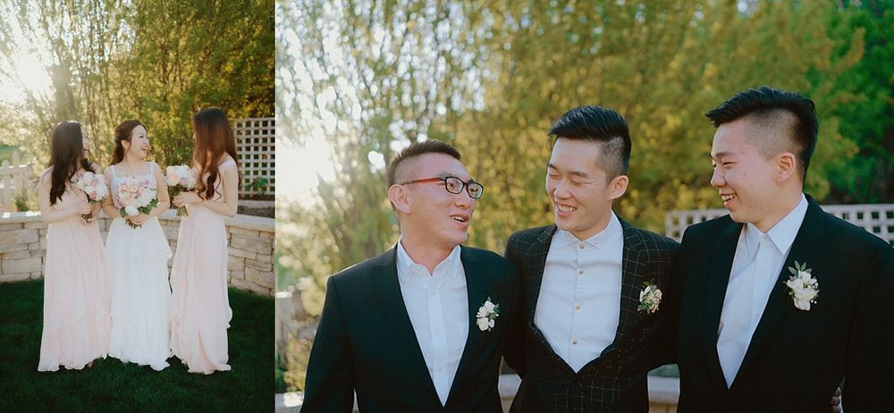 Wedding party poses in formal attire against natural garden backdrop.