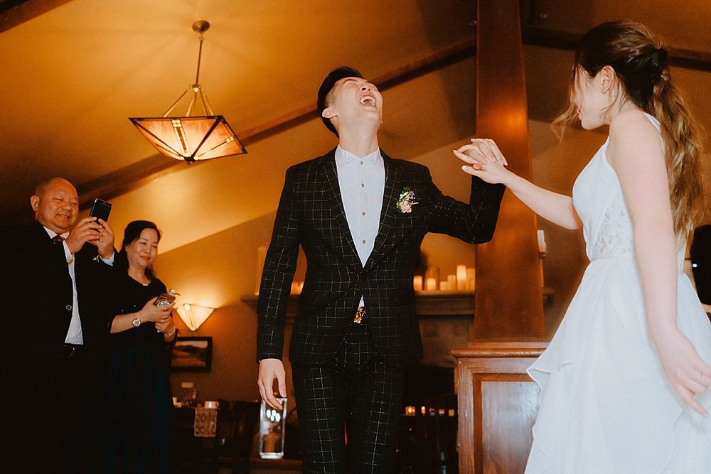 Wedding celebration in a lodge-style venue with warm lighting and dancing guests.