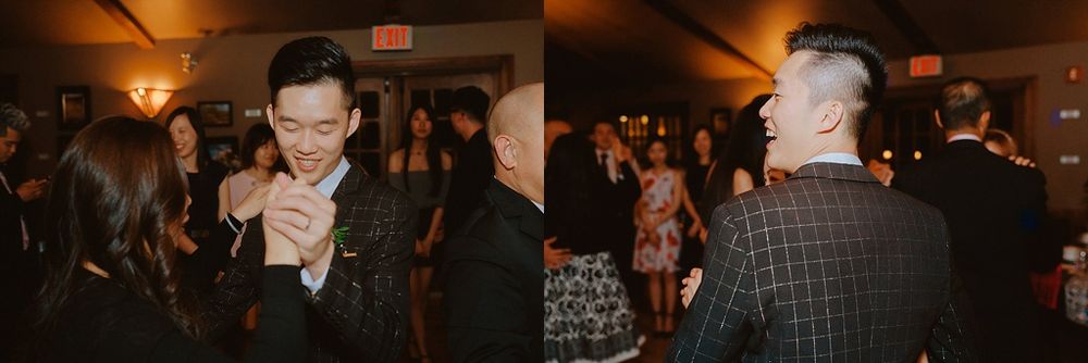 People dancing and celebrating at an indoor wedding reception with warm lighting and a festive atmosphere.