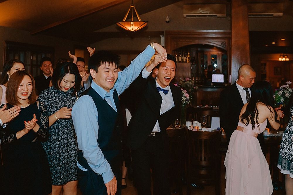Guests enjoying themselves on a crowded dance floor at an evening celebration.