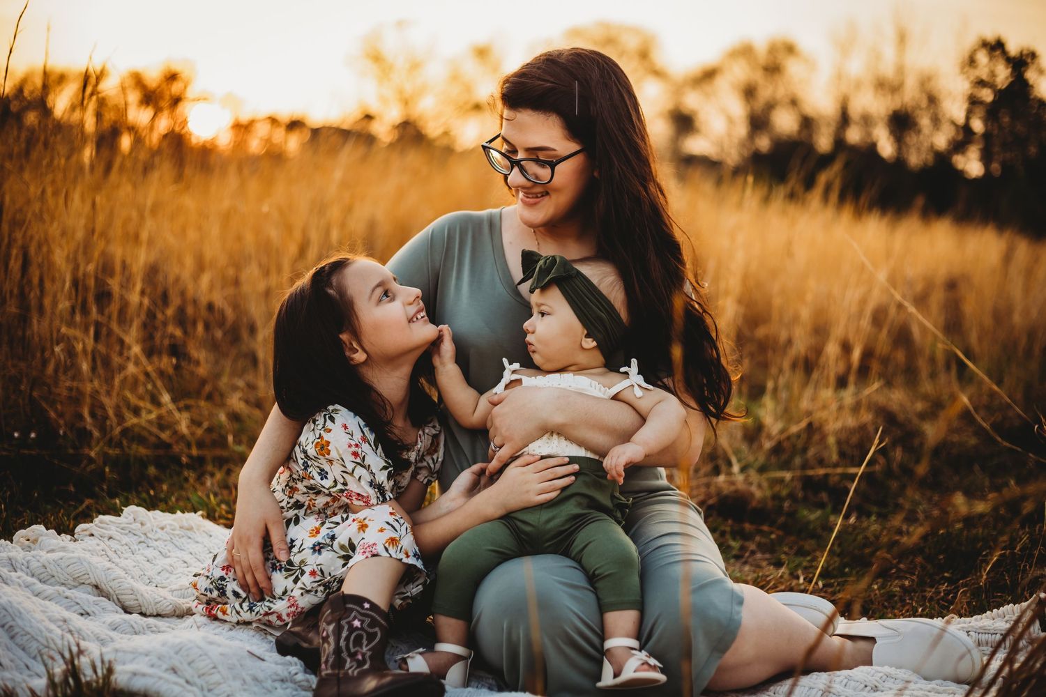 family in wheat field enjoys the sunset in New Haven, CT