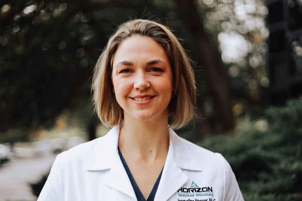 Medical professional in white coat outdoors.