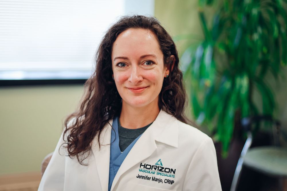 Healthcare professional in white coat at medical office.
