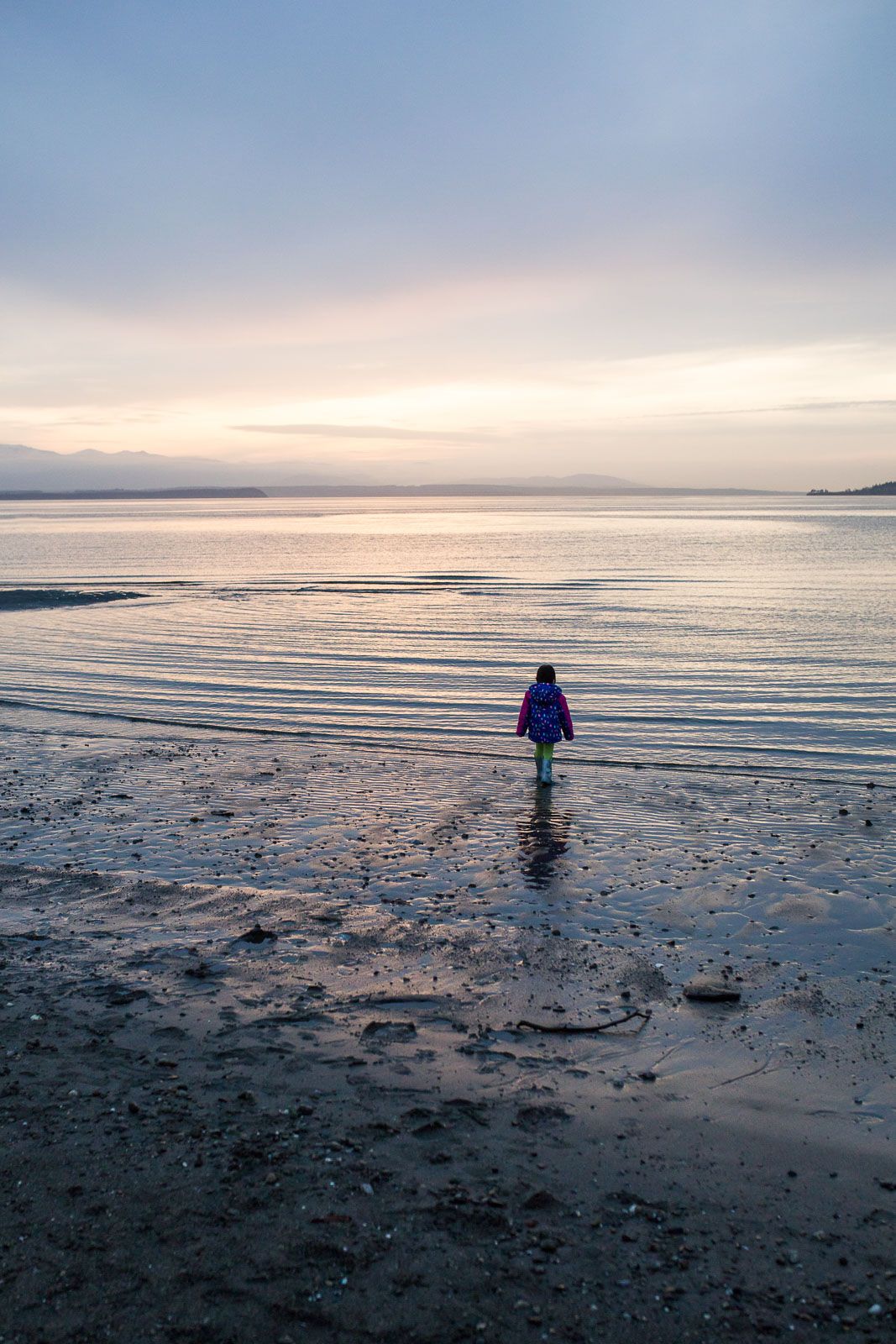 Little girl walking into the ocean