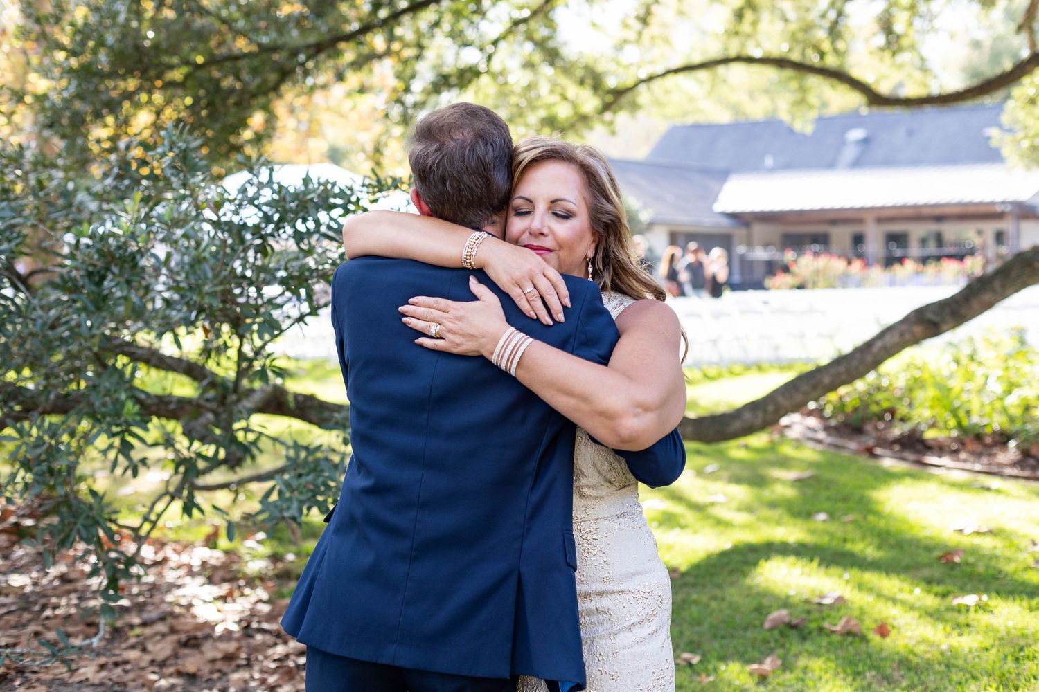 mom hugs son on wedding day