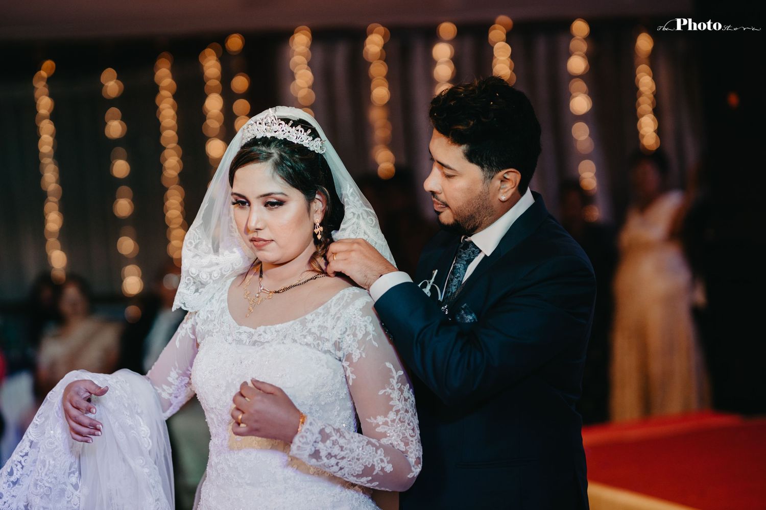 An intimate wedding moment captured under string lights during the reception.