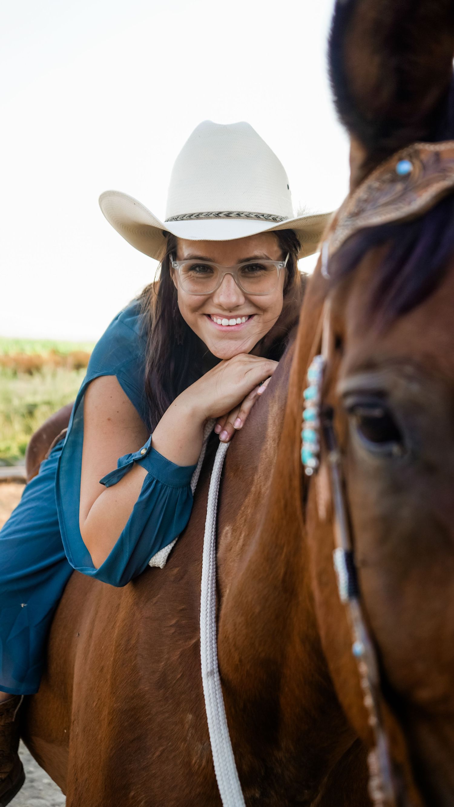 A person in a white cowboy hat poses with a brown horse in a series of close-up shots.