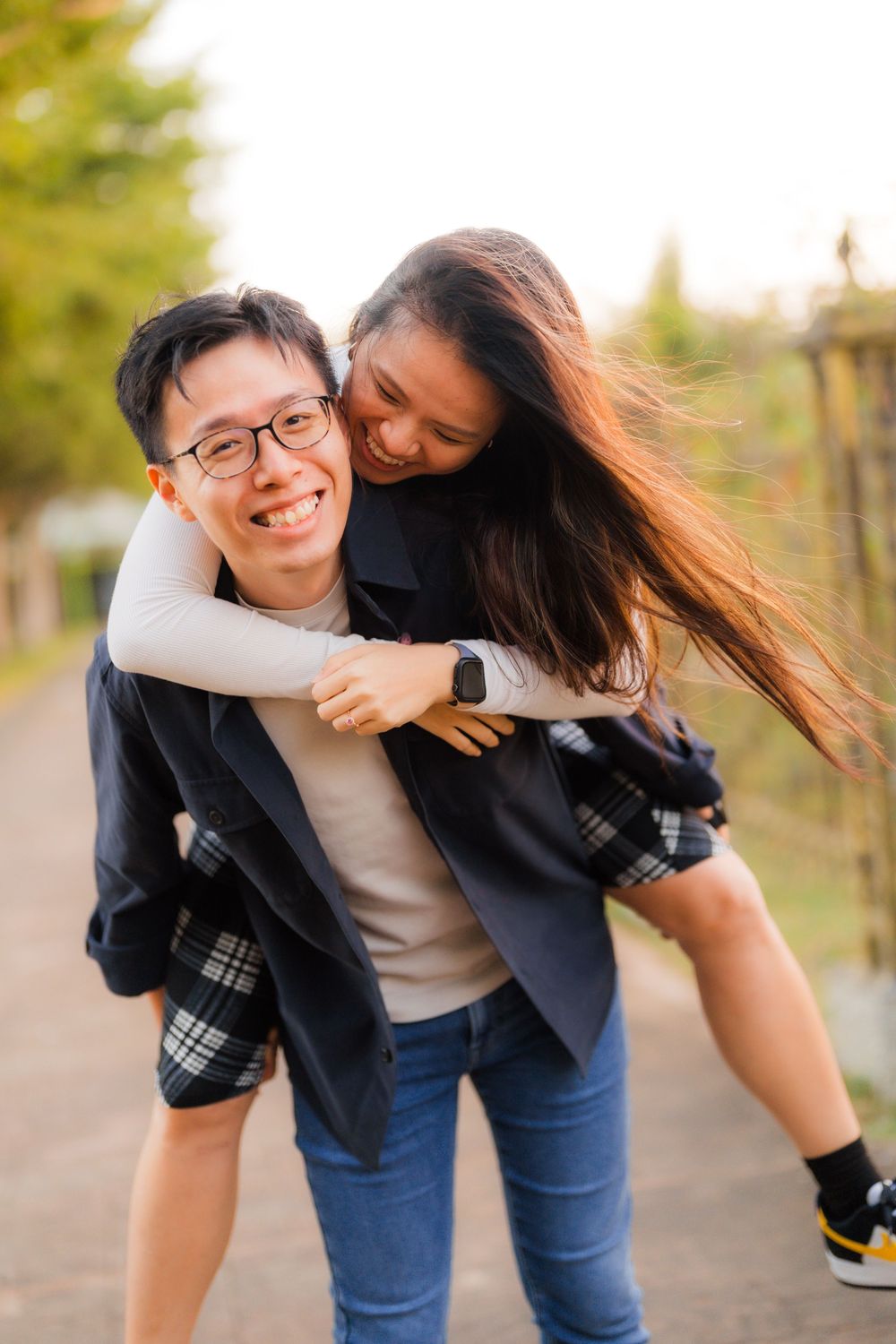Playful piggyback ride moment captured in outdoor setting.