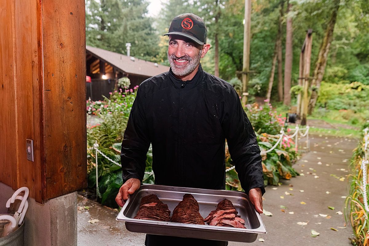 Server presenting freshly prepared meat for wedding dinner