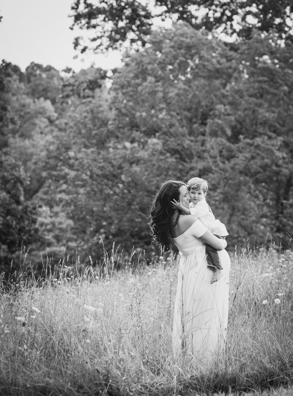 Black and white portrait series in summer meadow with wildflowers.