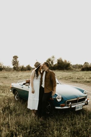 open field engagement session in ottawa with vintage car