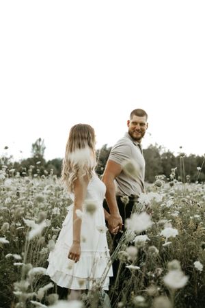 open field engagement session in ottawa with flowers