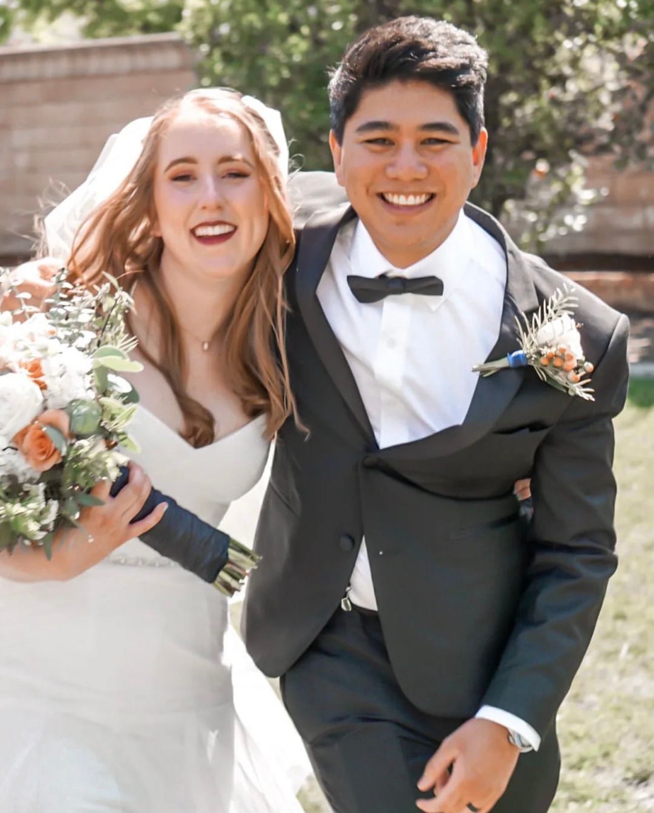 A joyful Christian couple walks together, beaming with happiness on their special day at an intimate Stockton wedding