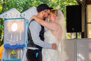 Wedding reception with dancing couples under string lights.