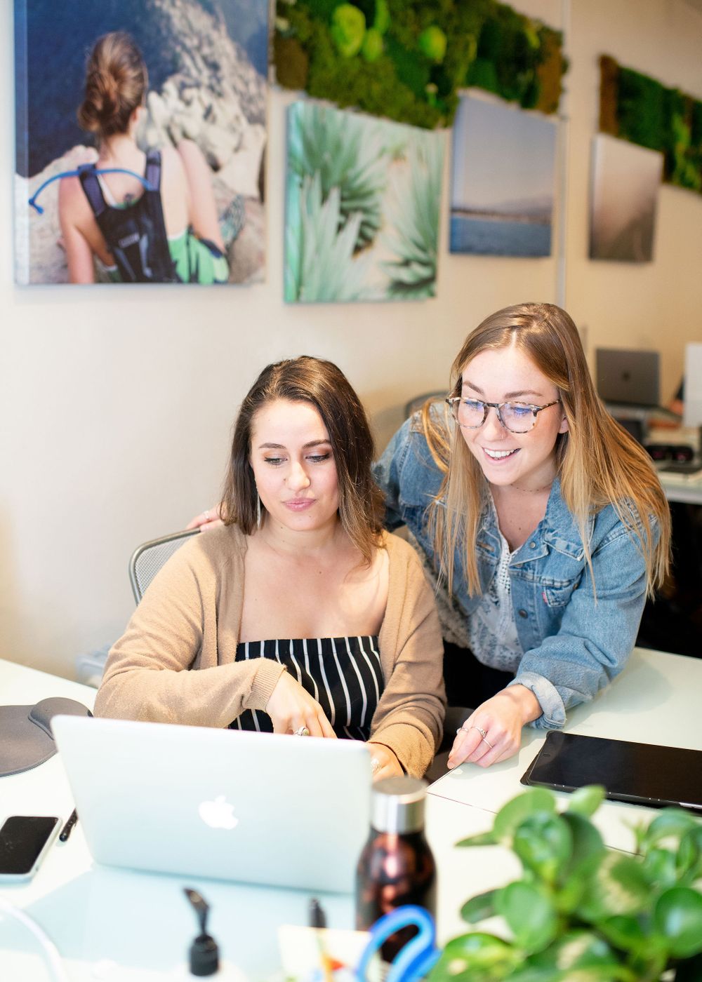 women in the office looking over work together
