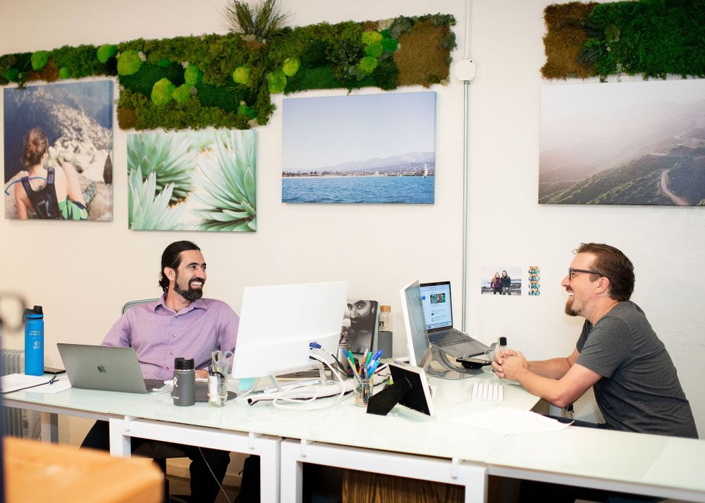 men sitting across from one another at a desk in a local santa barbara office